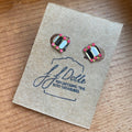Pair of earrings on a J.J. Dolle branded card.